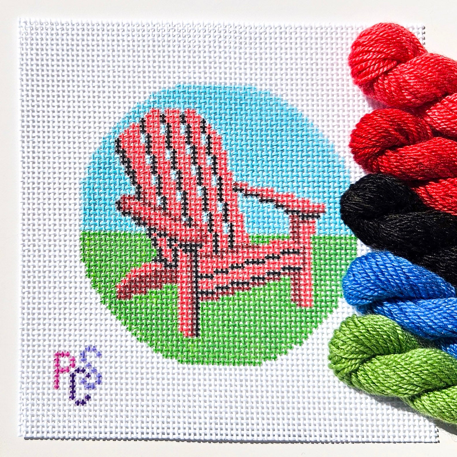 Red Muskoka chair needlepoint canvas with green grass and blue sky inspired by Canadian cottage life