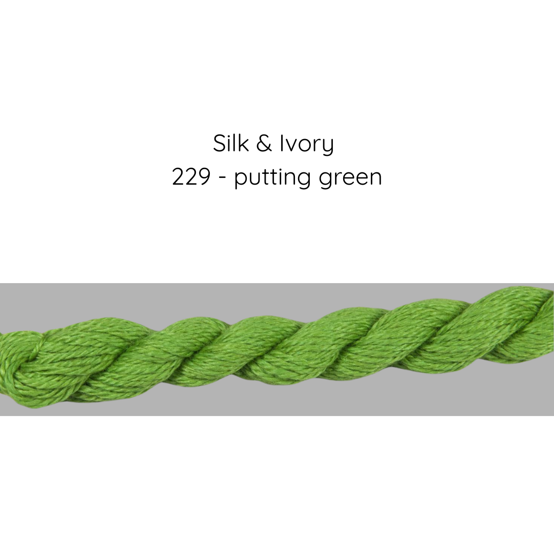 Green yarn on a gray background with text 'Silk & Ivory 229 - putting green'.