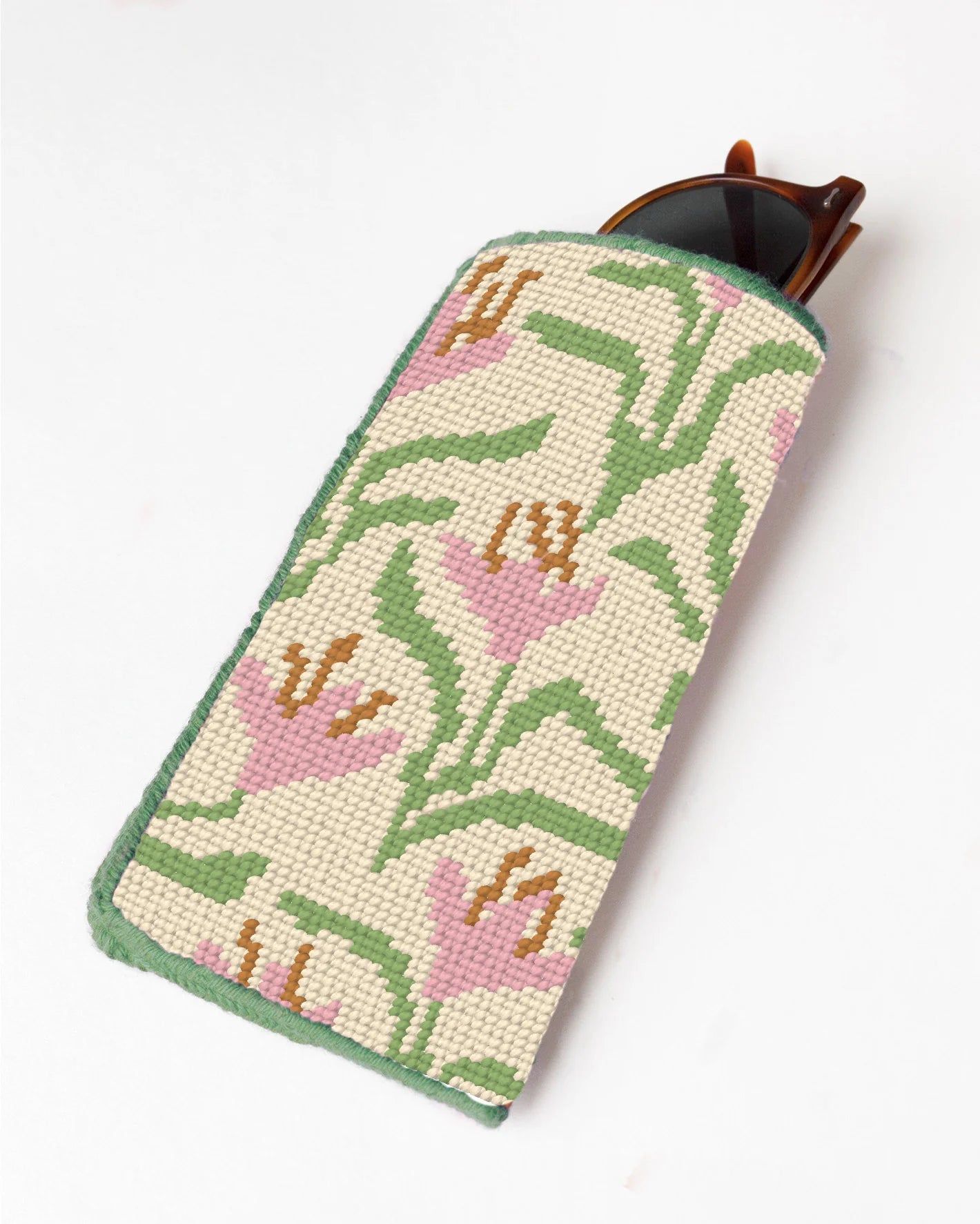 Needlepoint case with floral pattern on a white background