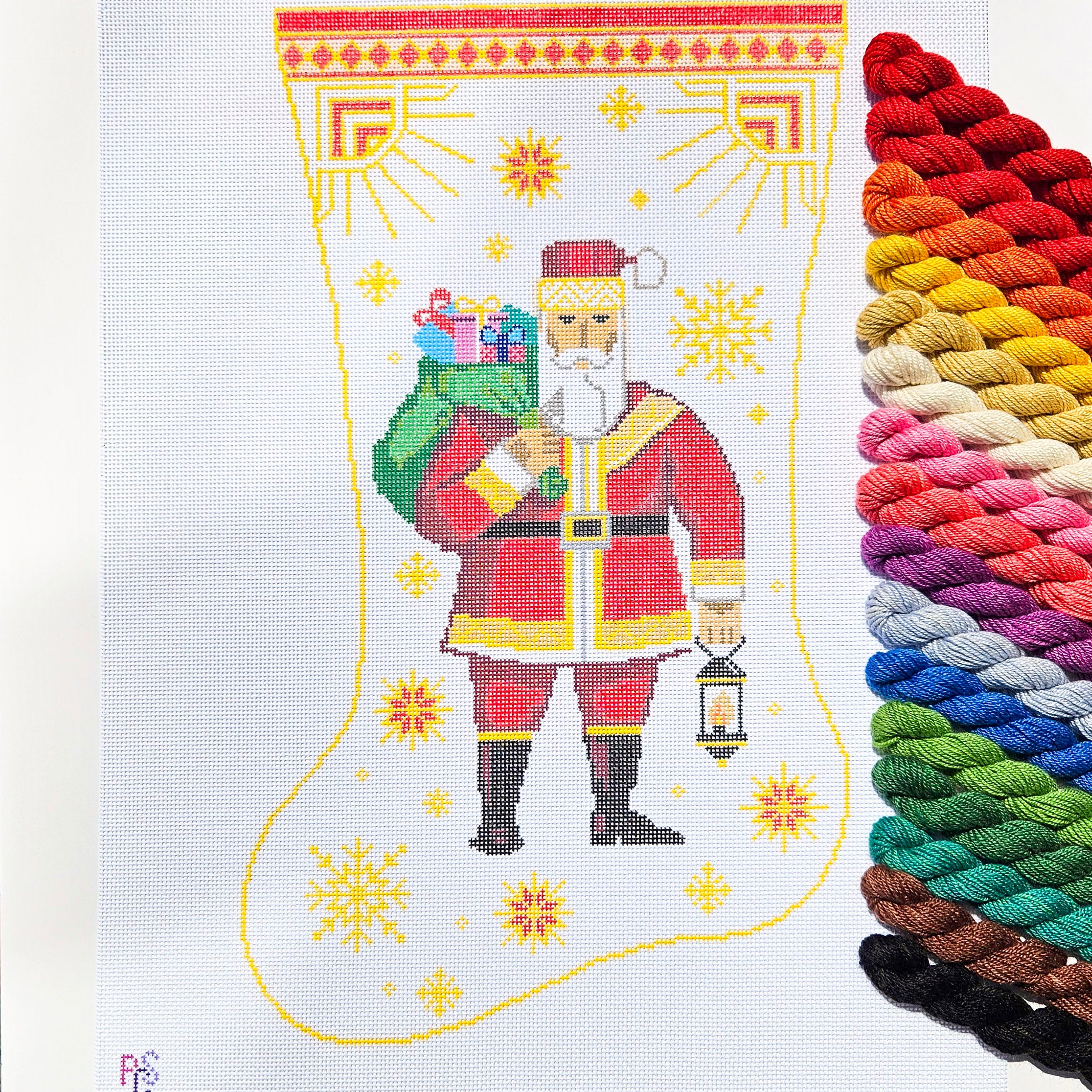 Hand-painted Art Deco Lantern Santa Christmas stocking needlepoint canvas featuring Santa carrying gifts and holding a lantern beneath a geometric celestial border on 13 Count Mono Deluxe Canvas Dinky Dyes