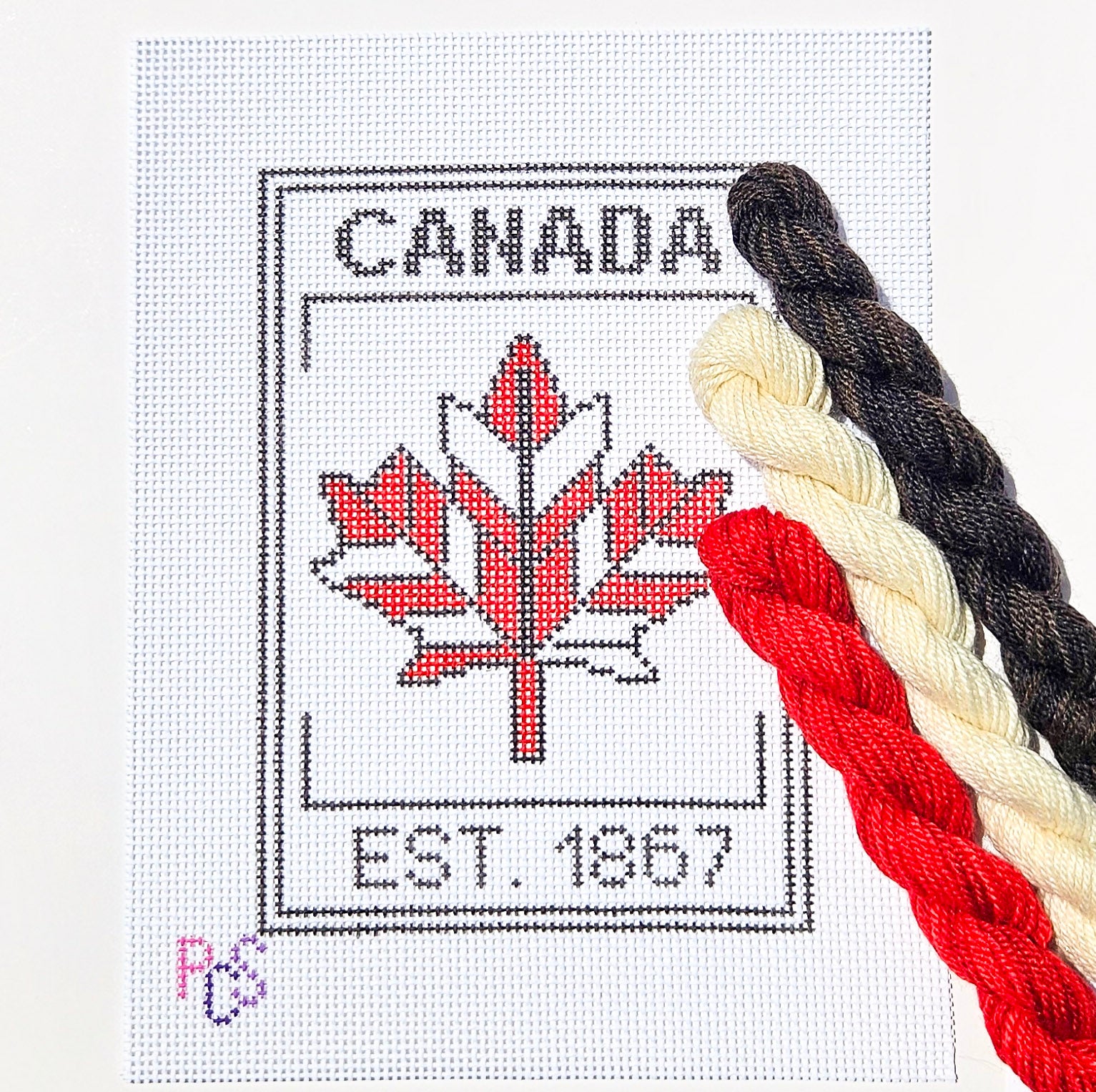 hand-painted Canada 1867 maple leaf needlepoint canvas featuring a modern red geometric maple leaf design on 13 Count Zweigart Mono Deluxe Canvas Dinky Dyes