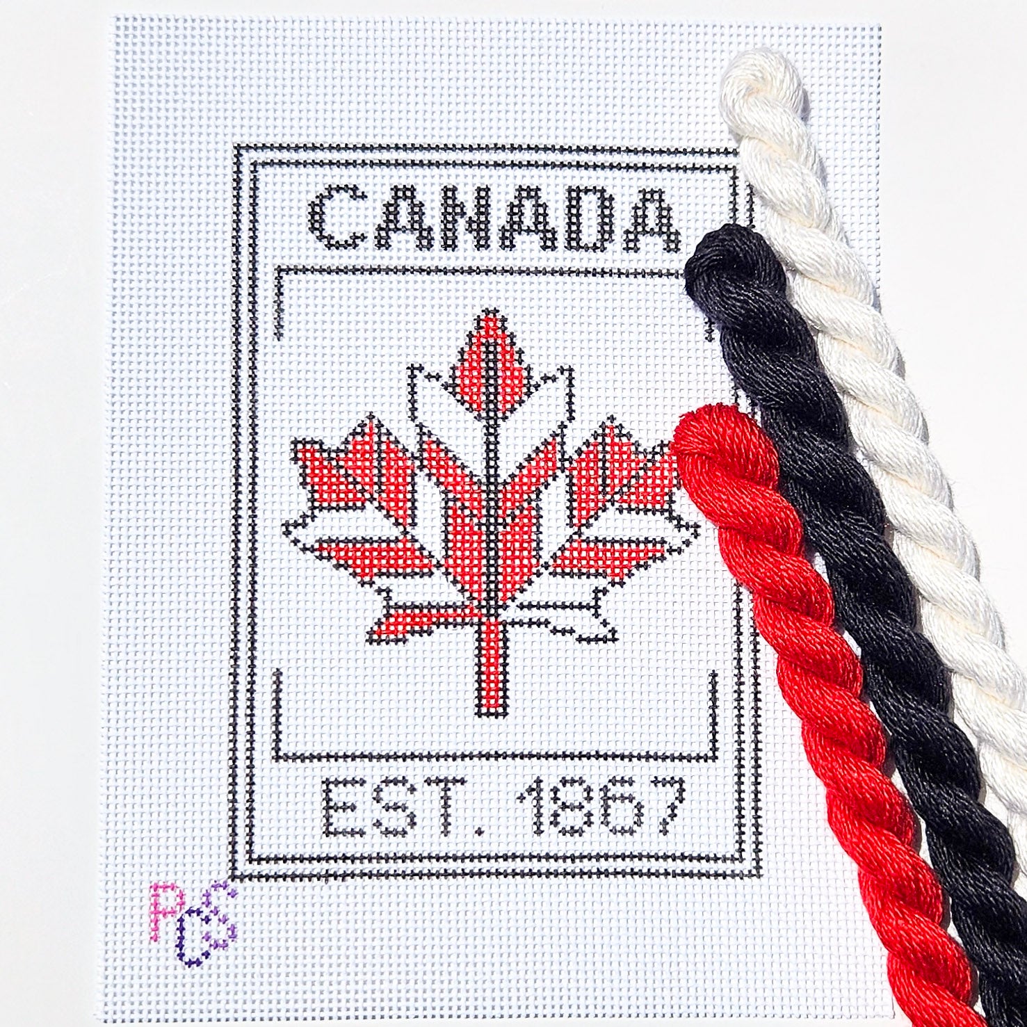 hand-painted Canada 1867 maple leaf needlepoint canvas featuring a modern red geometric maple leaf design on 13 Count Zweigart Mono Deluxe Canvas Silk and Ivory
