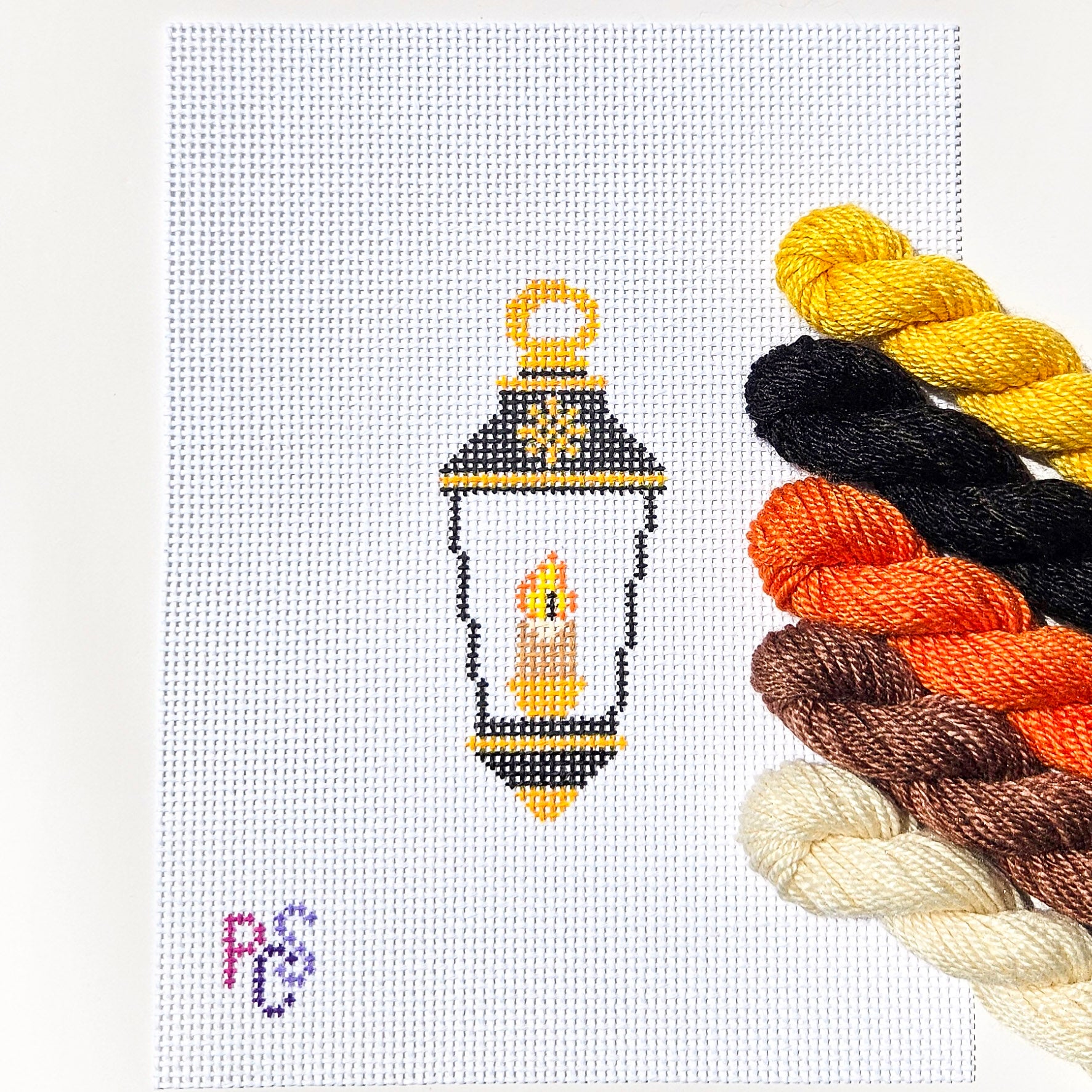 Hand-painted Christmas lantern ornament needlepoint canvas featuring a glowing candle on premium 13 Count Zweigart Mono Deluxe Canvas Dinky Dyes