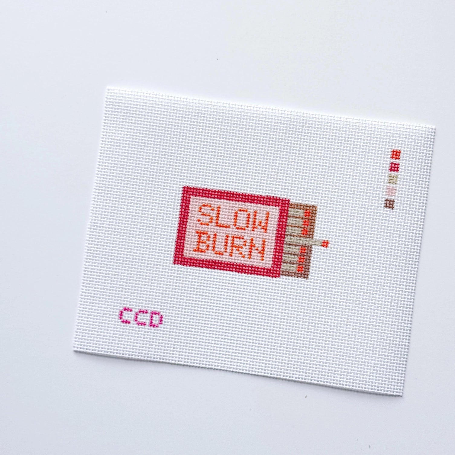 Needlepoint Canvas with 'SLOW BURN' text on a white background