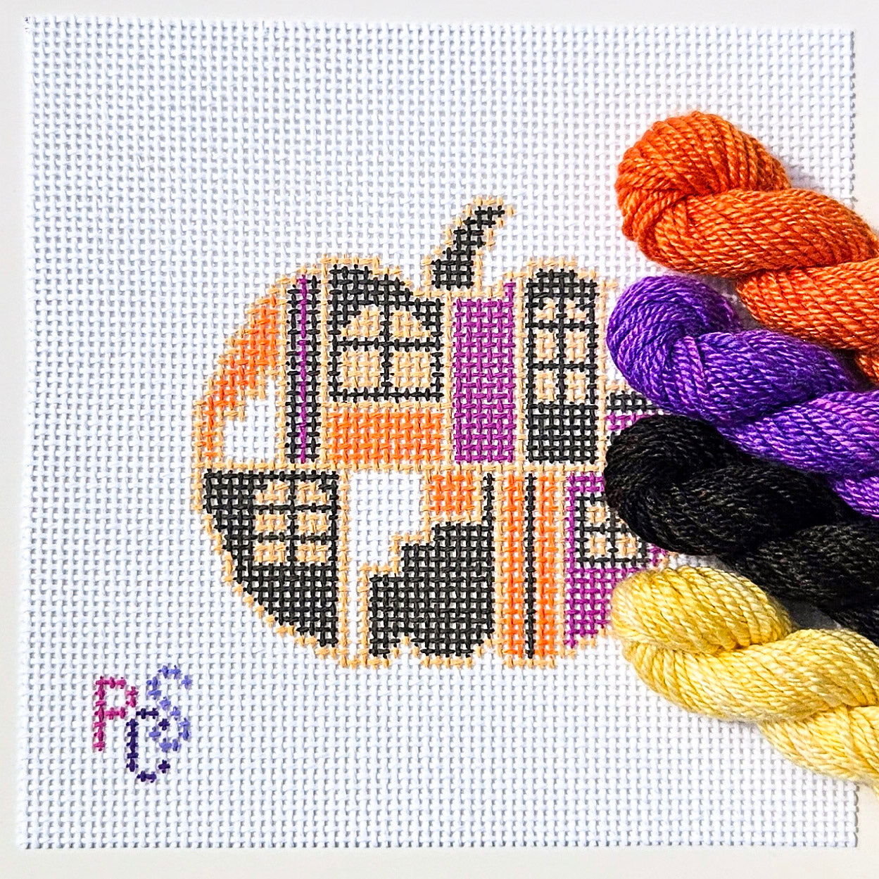 Halloween pumpkin needlepoint canvas with purple, orange and black haunted windows on white canvas kitted with Dinky Dyes