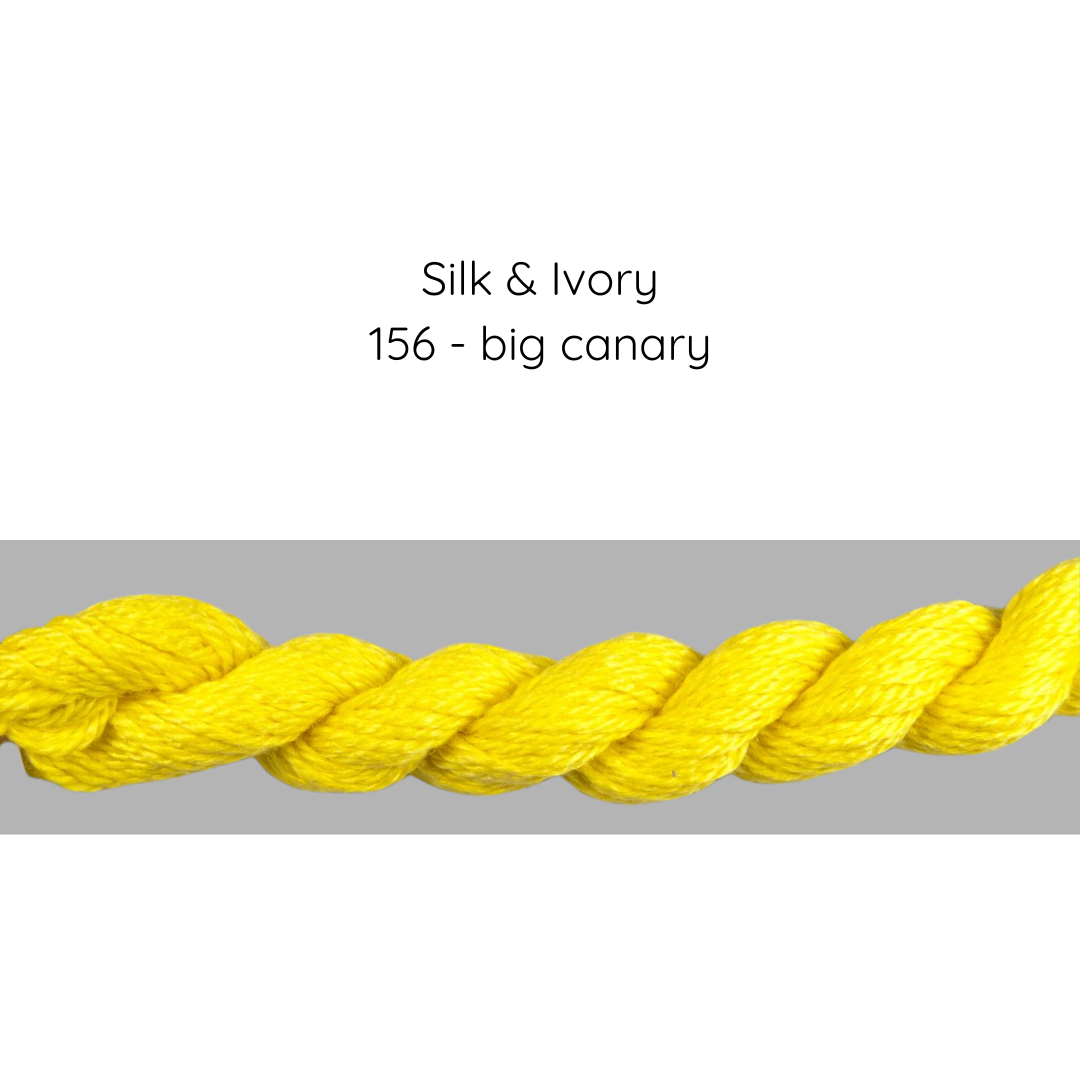Yellow yarn skein labeled 'Silk & Ivory 156 - big canary' on a gray background