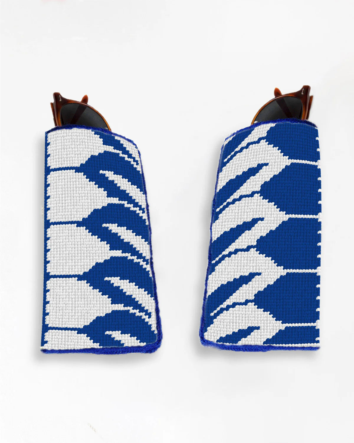 Two blue and white patterned cases for sunglasses on a white background