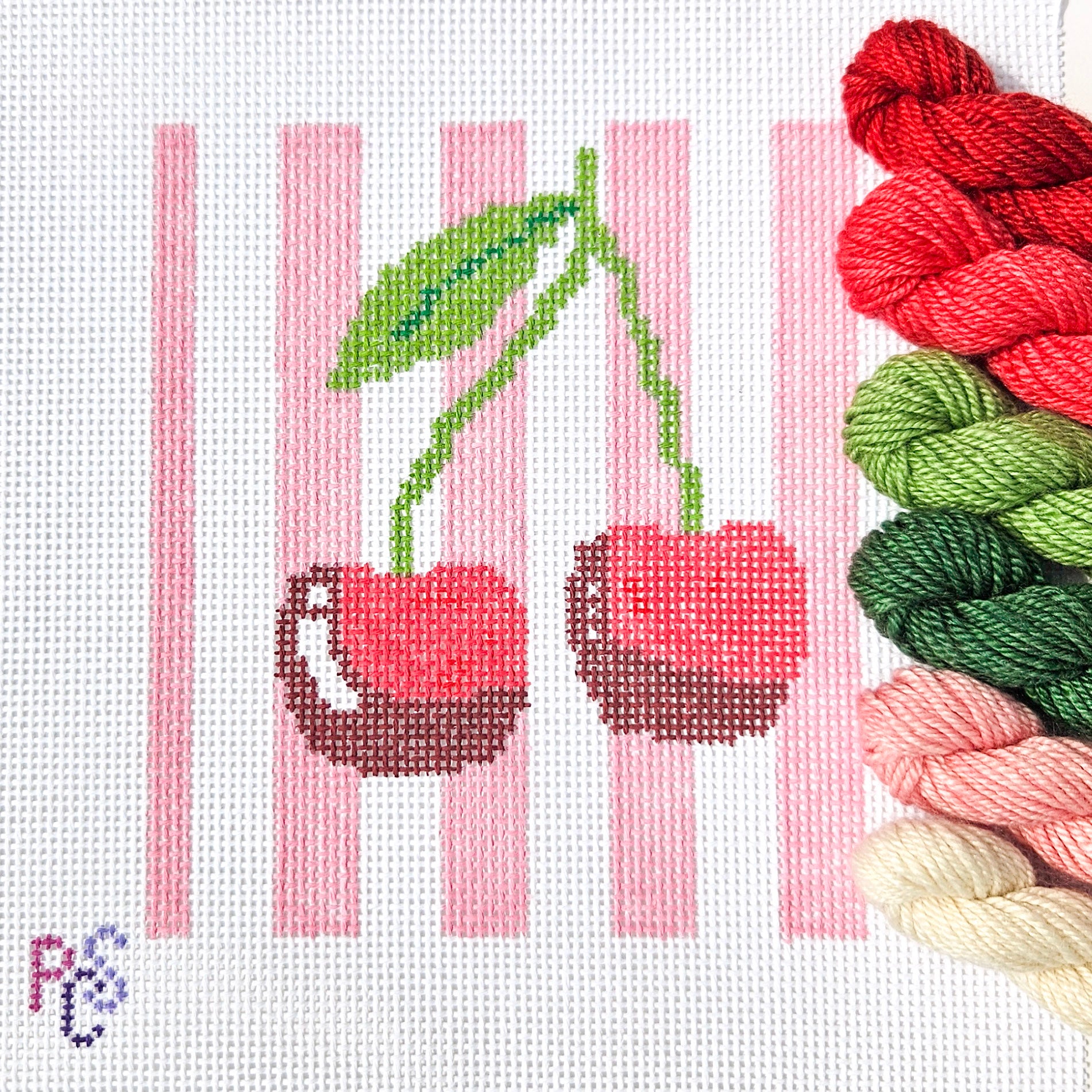 Hand-painted Sweet Cherries Needlepoint Kit on 13 Count Zweigart Mono Deluxe Canvas featuring two red cherries with green leaves on a pink and white striped background Dinky Dyes